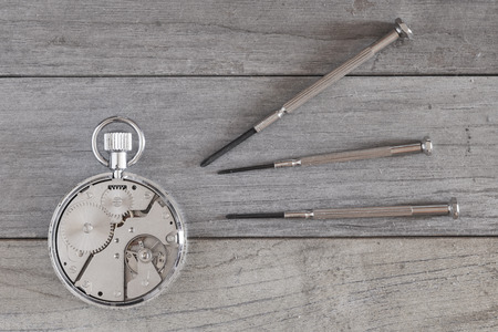 repairing an old and broken clockの写真素材