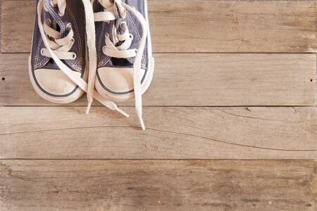 Picture of a child shoe on a wooden floorの写真素材
