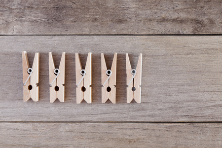 Some clothespin on a wooden surface
