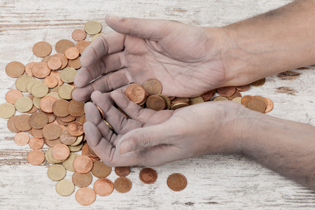 a poor hands taking some coins