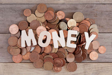 Word money over a pile of euros coins