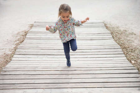 Four years girl jumping and playingの写真素材