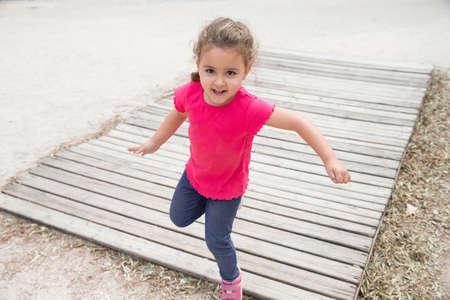 Four years girl jumping and playingの写真素材