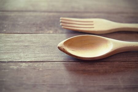 Close-up of wooden fork and spoon on tableの写真素材