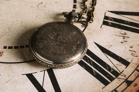 Close-up of beautiful vintage pocket watch on dial with Roman numeralsの写真素材