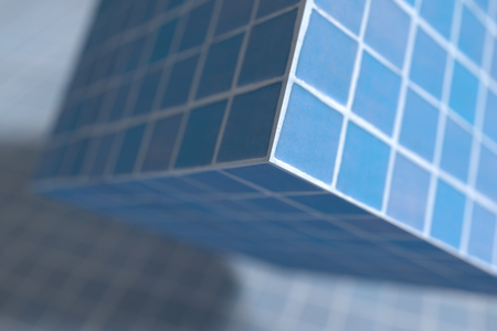 3d rendering of close-up of blue glazed cube under tiled floorの写真素材