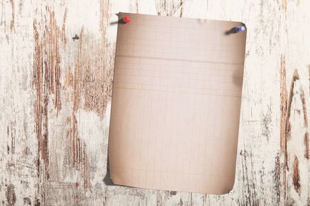 3d rendering of a lined page pinned on shabby wooden planksの写真素材