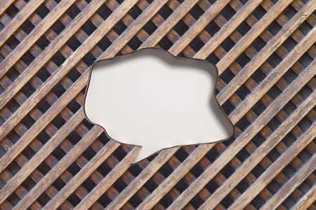 3D rendering of speech bubble with blank space carved in wooden fence backgroundの写真素材