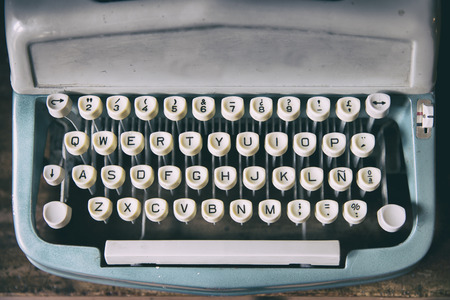 Keyboard placed on retro typewriter. Horizontal indoors shot