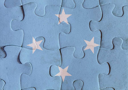 Illustration of a flag of Federated States of Micronesia over some puzzle pieces. Its a JPG image.の写真素材