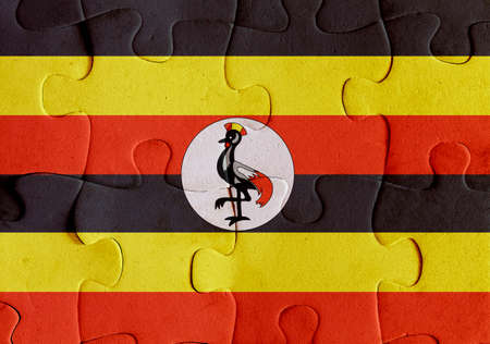 Illustration of a flag of Uganda over some puzzle pieces. Its a JPG image.の写真素材
