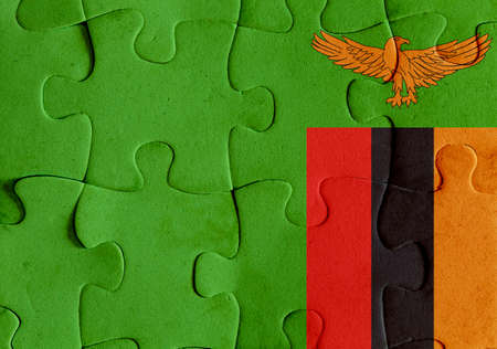 Illustration of a flag of Republic of Zambia over some puzzle pieces. Its a JPG image.の写真素材