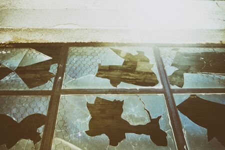 Detail of an old broken window on an abandoned building