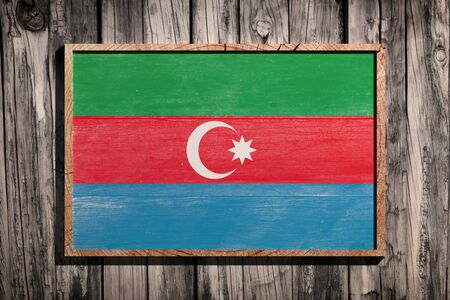 3d rendering of Azerbaijan flag on a wooden frame over a planks wallの写真素材