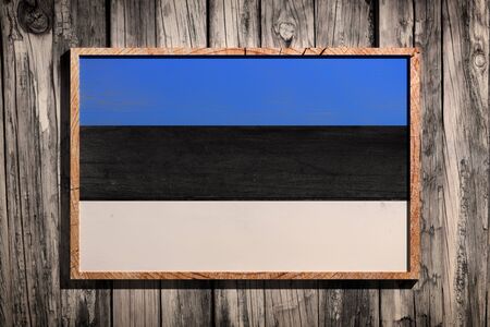 3d rendering of Estonia flag on a wooden frame over a planks wallの写真素材