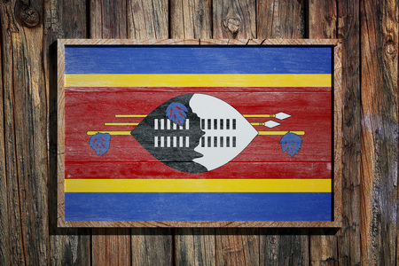 3d rendering of Swaziland flag on a wooden frame over a planks wallの写真素材