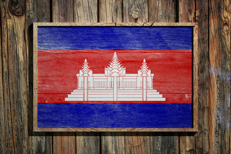 3d rendering of Cambodia flag on a wooden frame over a planks wallの写真素材