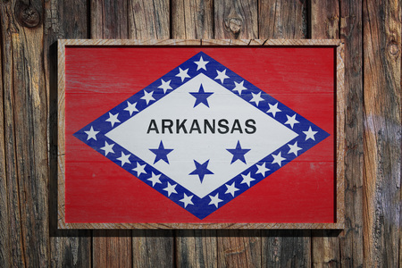 3d rendering of an Arkansas State USA flag on a wooden frame and a wood wallの写真素材