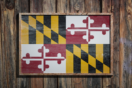 3d rendering of a Maryland State USA flag on a wooden frame and a wood wallの写真素材