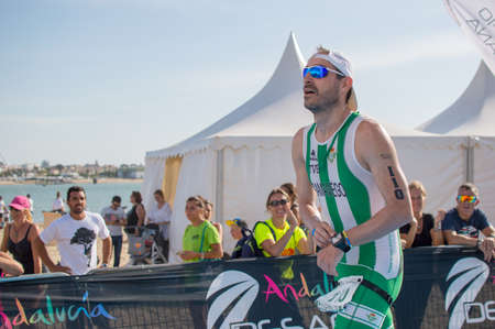 Athletes finish running this extreme triathlon on the beach of the Do?a National Park. In theのeditorial素材