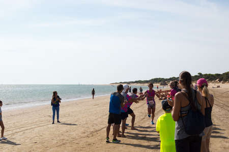 Athletes finish running this extreme triathlon on the beach of the Do?a National Park. In theのeditorial素材