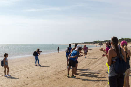 Athletes finish running this extreme triathlon on the beach of the Do? ? ana National Park. In theのeditorial素材