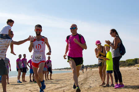 Athletes finish running this extreme triathlon on the beach of the Do? ? ana National Park. In theのeditorial素材