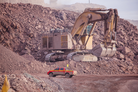 Big shovel loading of copper ore near to pickup truck