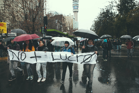 Santiago, Chile - August 18, 2011: Chilean Students carrying a banner with the slogan "No + Lucro", (No more Profit), during a demonstration of students, teachers and workers demanding the government to improve education quality, Santiago, Chileのeditorial素材