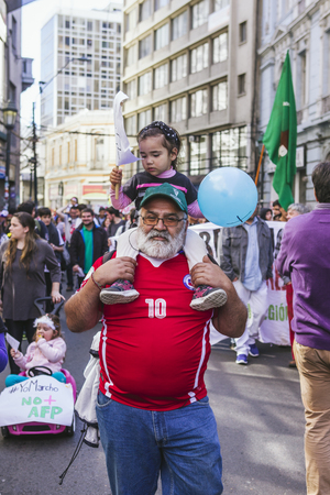 Valparaiso, Chile - August 21, 2016: Grandfather and granddaughter protest the pension system in Chile. Chileans marched through Valparaiso's streets, demanding an end to the private pension system (AFP) created during the Pinochet dictatorship.のeditorial素材