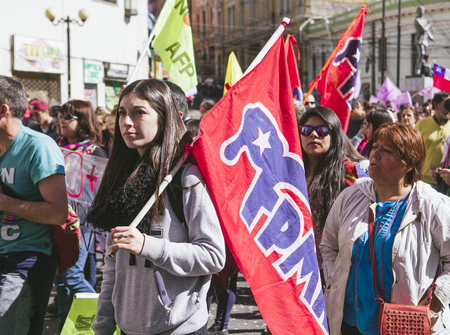 Valparaiso, Chile - August 21, 2016: A young woman carries a FPMR flag, "Frente Patriotico Manuel Rodriguez" (Manuel Rodriguez Patriotic Front) during a march against pension system. Chileans marched through Valparaiso's streets, demanding an end to the pのeditorial素材