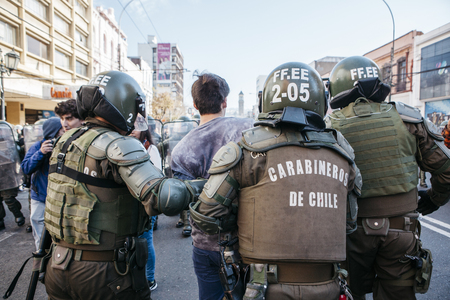 Valparaiso, Chile - June 01, 2017: Protester arrested by the Chilean riot police during a protest in the center of Valparaiso, following President Michelle Bachelets annual state-of-the-union speech to Congress.のeditorial素材