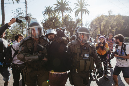 Valparaiso, Chile - June 01, 2017: Protester arrested by the Chilean riot police during a protest in the center of Valparaiso, following President Michelle Bachelets annual state-of-the-union speech to Congress.のeditorial素材