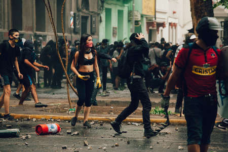 SANTIAGO, CHILE-NOVEMBER 8, 2019 - Protesters face riot police during the protests against the...