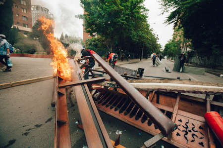 SANTIAGO, CHILE-NOVEMBER 8, 2019 - Protesters barricade with looted furniture from the