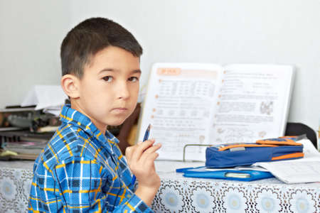 Boy is doing his homeworkの写真素材