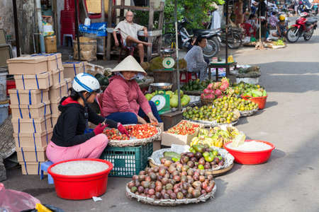 NHA TRANG, VIETNAM - DECEMBER 18: Vietnamese women are selling fruits at the wet market on December 18, 2015 in Nha Trang, Vietnam.のeditorial素材