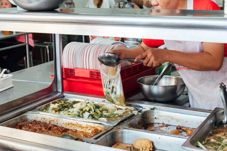 BANGKOK, THAILAND - APRIL 24: Woman pouring soup to the plastic bag on April 24, 2016 in Bangkok, Thailand.のeditorial素材
