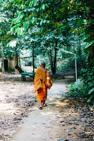 KRABI, THAILAND - APRIL 10: Buddhist monk walking through the rainforest on April 10, 2016 in Krabi, Thailand.のeditorial素材