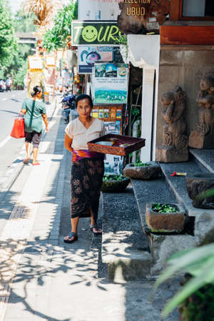 UBUD, INDONESIA - FEBRUARY 25: Balinese woman in traditional clothes making offerings to the Gods, Ubud, Indonesia on February 25, 2016のeditorial素材