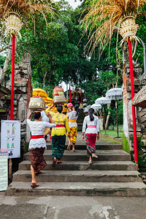 UBUD, INDONESIA - MARCH 2: Women walks up the stairs during the celebration before Nyepi (Balinese Day of Silence) on March 2, 2016 in Ubud, Indonesia.のeditorial素材