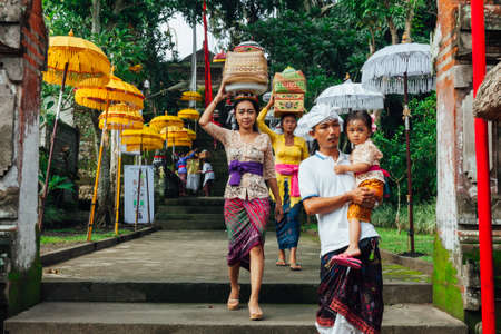 UBUD, INDONESIA - MARCH 2: Family walks down the stairs during the celebration before Nyepi (Balinese Day of Silence) on March 2, 2016 in Ubud, Indonesia.のeditorial素材