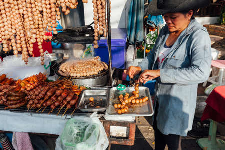 CHIANG MAI, THAILAND - AUGUST 21: Thai woman cooks meatballs at the Sunday Market (Walking Street) on August 21, 2016 in Chiang Mai, Thailand.のeditorial素材