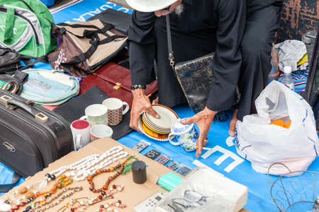 KUALA LUMPUR, MALAYSIA - AUGUST 03: Man sells stuff at the flea market on August 03, 2016 in Kuala Lumpur, Malaysia.のeditorial素材