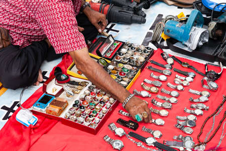 KUALA LUMPUR, MALAYSIA - AUGUST 03: Man sells watches and rings at the flea market on August 03,...