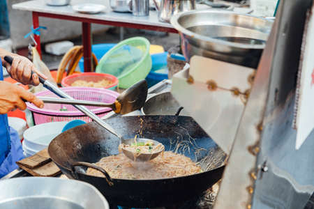 GEORGE TOWN, MALAYSIA - MARCH 23: Chef cooks stir-fried noodles at Kimberly Street Food Night Market on March 23, 2016 in George Town, Malaysia.の写真素材