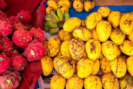 Mangoes and dragon fruits at the market stall in Chiang Mai, Thailand.の写真素材