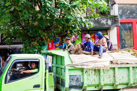UBUD, INDONESIA - MARCH 2: Workers rides in the back of the truck on March 2, 2014 in Ubud,...