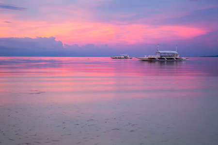 Stunning view of the sunset on the Philippine beach. Doljo beach, Panglao, Bohol, Philippines.の写真素材