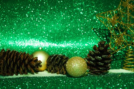 Christmas decorations and cones on green and purple background.の写真素材